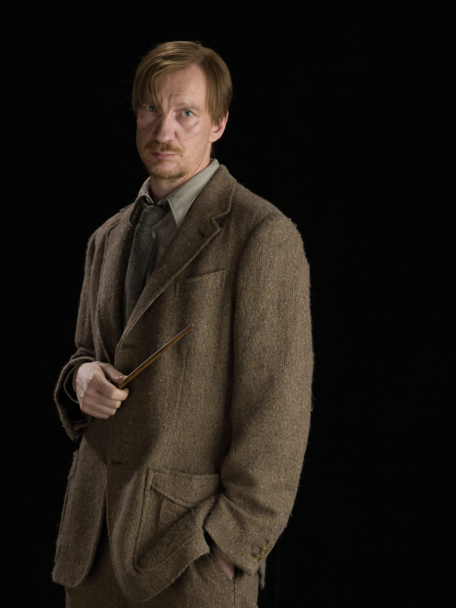 Lupin looking concerned with his wand 