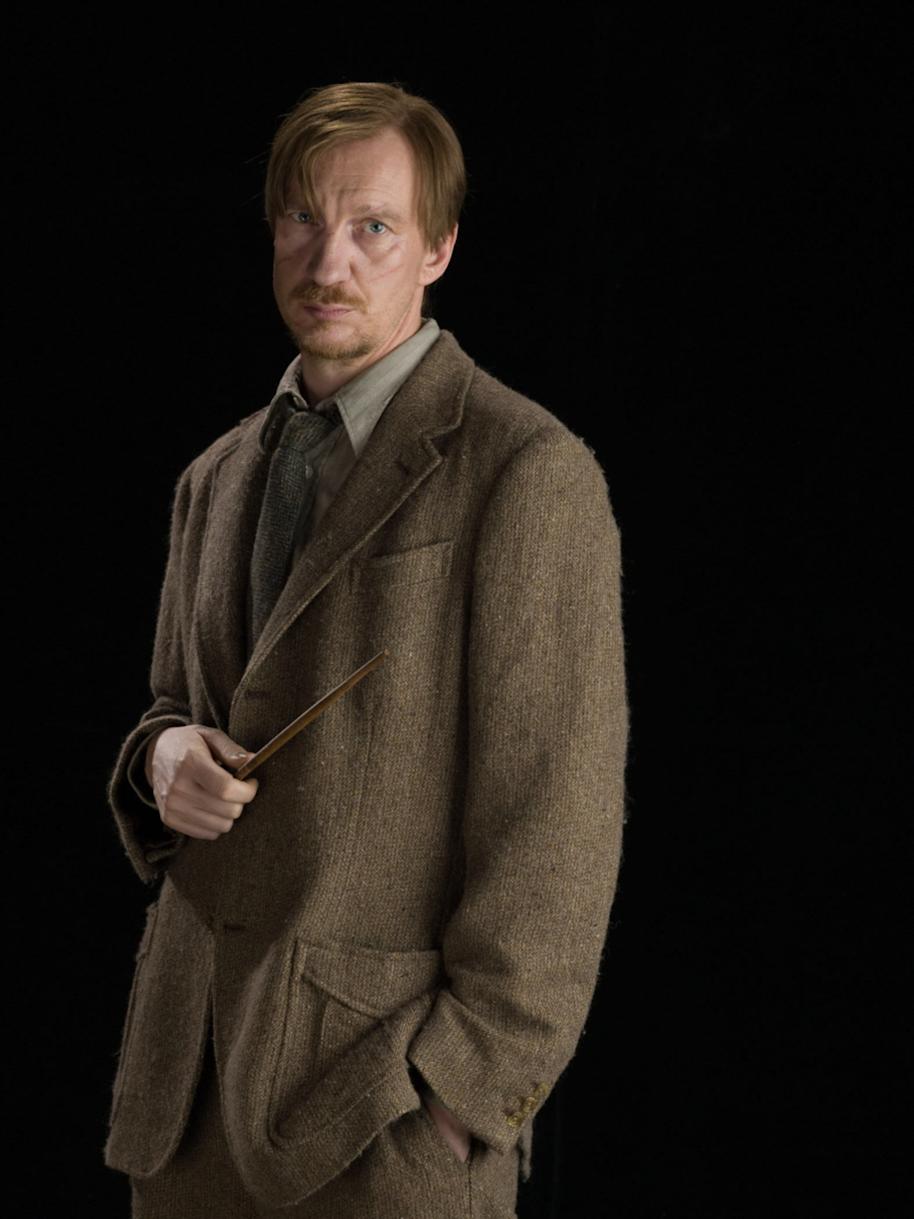Lupin looking concerned with his wand 