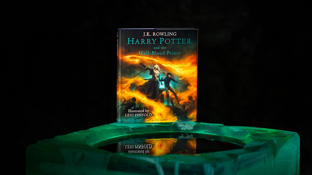 Cover of the Half-Blood Prince Illustrated Edition showing Harry and Dumbledore surrounded by fire in the cave
